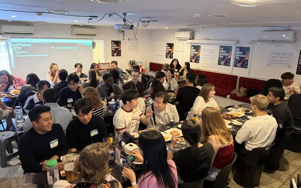 A full room of guests seated at tables during a nurio international party