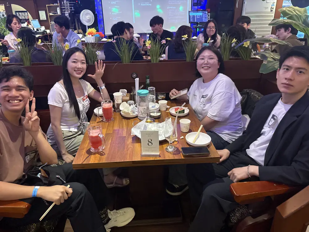 Guests from different countries sharing a table at a nurio party
